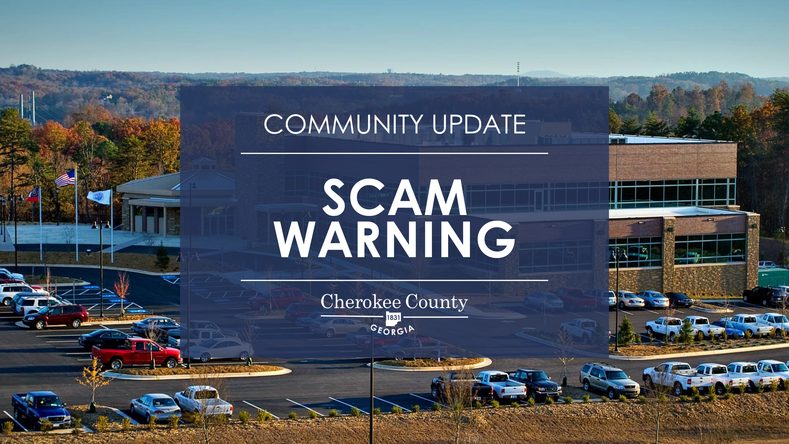 background photo of county administration building. Scam Alert text